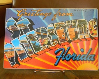 Greetings from St. Petersburg sign - photo on wood