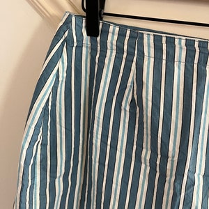 May include: A blue and white striped skirt with a wide waistband.