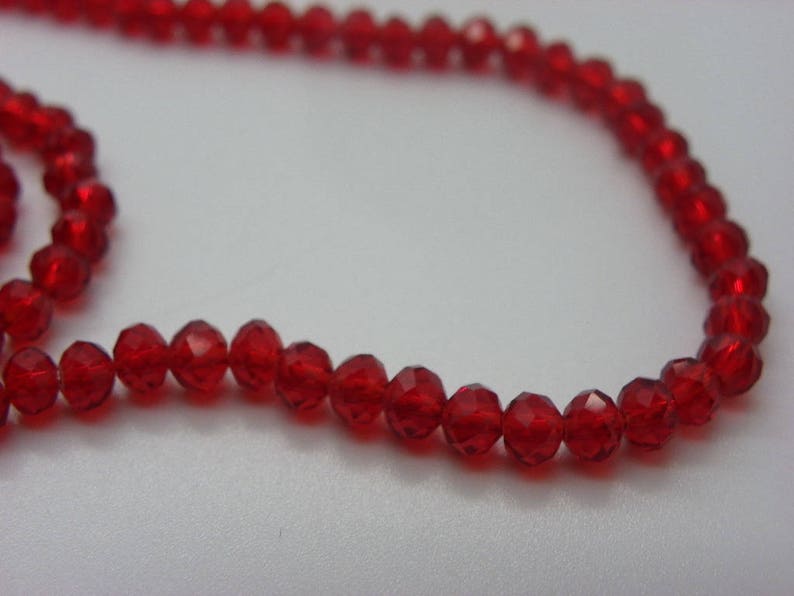 White 100 4 mm abacus has red faceted crystal glass beads