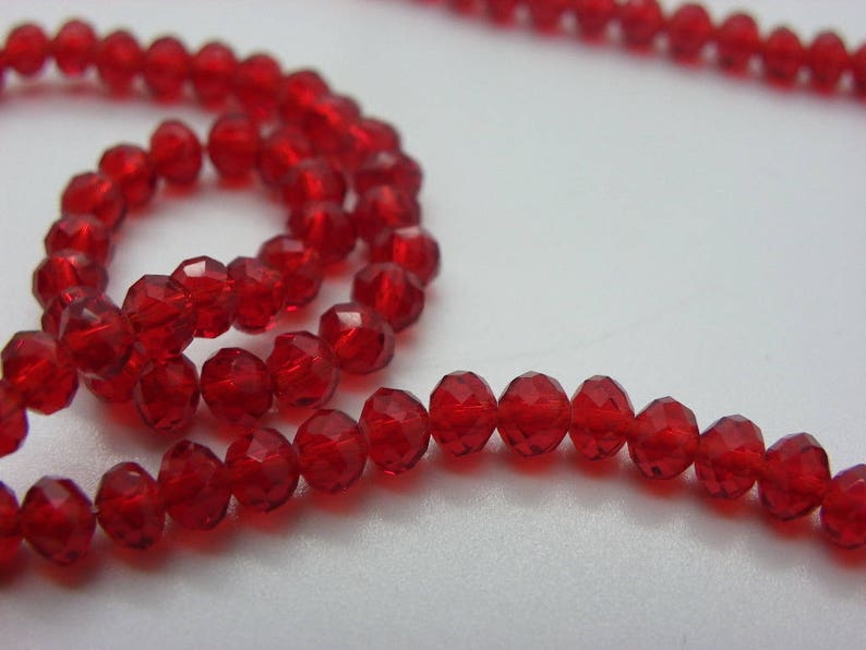 White 100 4 mm abacus has red faceted crystal glass beads