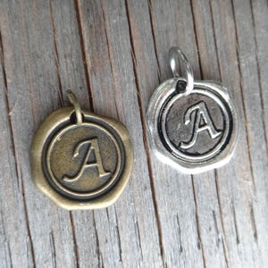 Add a letter . Initial Letter . Custom Monogram . Oxidized silver medallion wax seal . Charm letter . Customize your jewelry. Tag. Charm