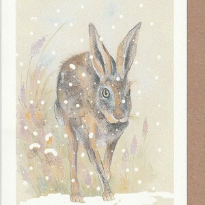 Hase Weihnachtskarte. Hase läuft im Schnee. Weihnachtskarte mit einem Hasen. Weihnachtskarten. Weihnachtskarte. Hasenkarte. Hase Aquarell