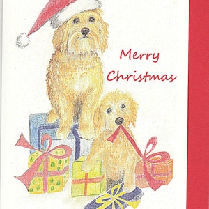 May include: A Christmas card featuring two golden doodle dogs, one wearing a Santa hat, sitting on top of wrapped presents. The card reads "Merry Christmas".