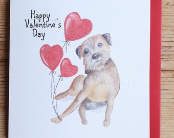 May include: A Valentine's Day card featuring a brown and white dog with three red heart-shaped balloons. The card reads "Happy Valentine's Day".