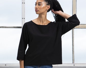 Loose fit sweatshirt. BLACK. Sustainable and Earth Friendly Production. Raw edge neckline and sleeves. Off the shoulder style.