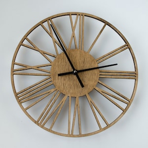 A brown wooden clock with black hour and minute hands. The clock face has a circular design with Roman numerals and a wood grain texture. The clock is a decorative wall clock.