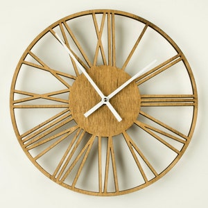A large, round, wooden clock with white Roman numeral markings and white hour and minute hands. The clock face is a light brown wood with a darker brown wood frame.