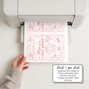 May include: A printer is shown printing two pink rodeo-themed invitations. The invitations feature the text "Olivia's First Rodeo!" along with illustrations of cowboy boots, cacti, and other rodeo-related graphics. The image also includes instructions for printing.
