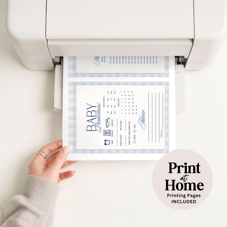 May include: A white printer outputting a baby shower game card with a light blue gingham border. The card features the text Baby Predictions and Advice, with sections for birth month, date, length, weight, eye color, hair color, and parent resemblance.