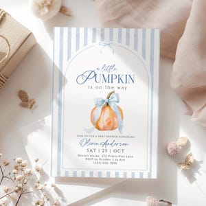 Little Pumpkin baby shower invitation with watercolor orange pumpkin, blue bow and blue striped design, editable fall baby shower Canva template.