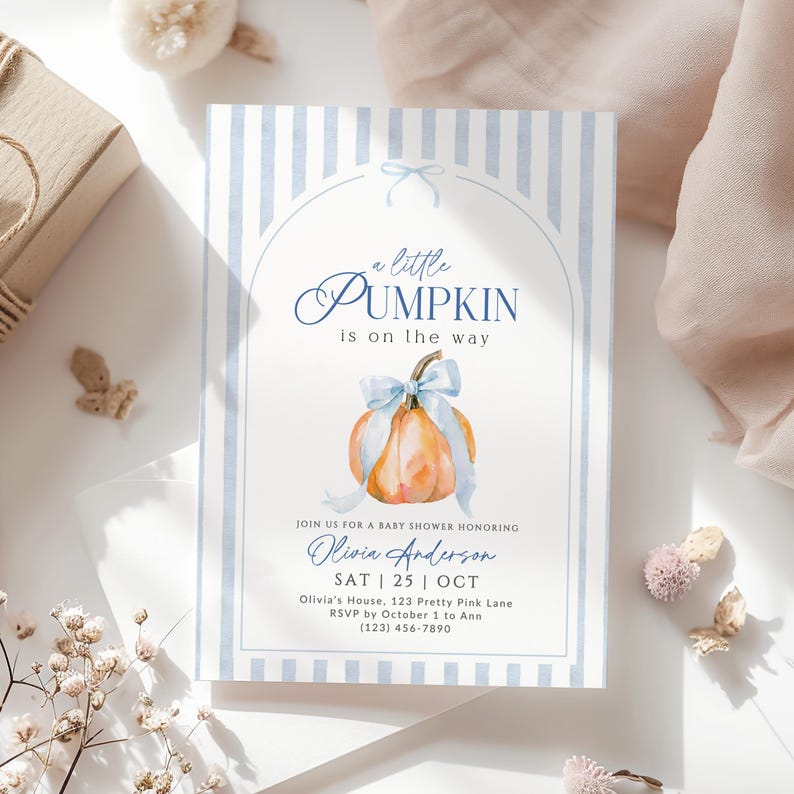 Little Pumpkin baby shower invitation with watercolor orange pumpkin, blue bow and blue striped design, editable fall baby shower Canva template.