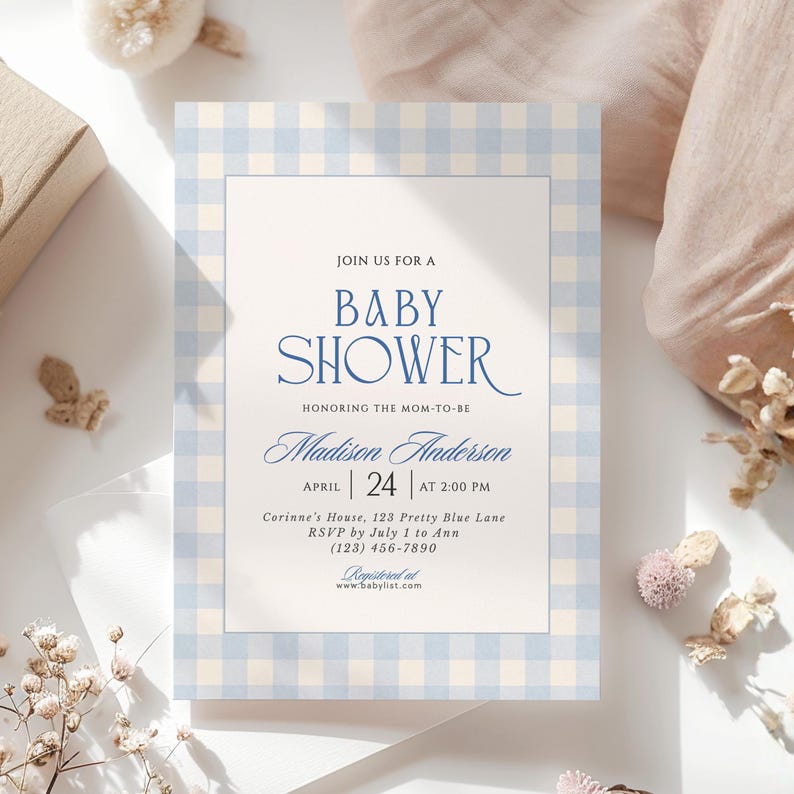 Editable blue gingham baby shower invitation template with elegant navy script, classic white center panel and soft watercolor gingham border.