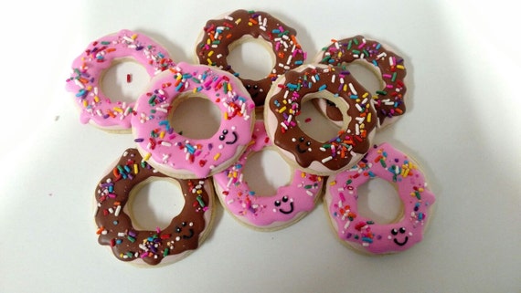 Hand decorated cookies as smiling donuts