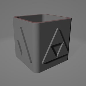 May include: A grey, square-shaped pencil holder with a raised triangular design on each side. The design is a stylised version of the Triforce, a symbol from the Legend of Zelda video game series.