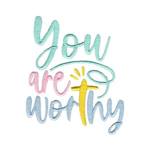 May include: Embroidered design with the text "You are worthy" in blue, pink, and yellow. A yellow cross with a sunburst is in the center of the design.