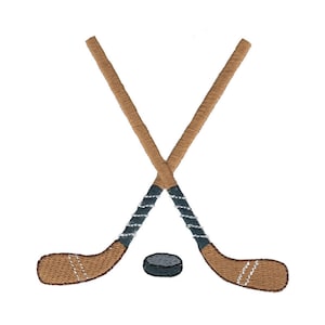 May include: Two brown hockey sticks crossed over each other with a black puck in the center.