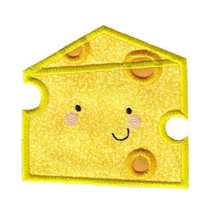 May include: A yellow felt cheese patch with a smiling face and holes. The cheese is outlined in yellow thread.