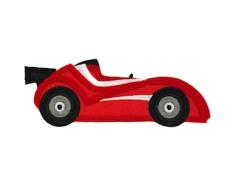 May include: A red race car with a black spoiler and white stripes. The car has gray wheels with black rims.