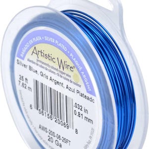 May include: A spool of 25 feet of silver-plated copper wire in blue. The wire is 20 gauge and 0.032 inches in diameter. The spool is labeled "Artistic Wire" and has the text "Silver Blue, Gris Argent, Azul Plateado" printed on it.