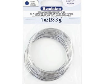 May include: A package of 1 ounce (28.3 grams) of stainless steel memory wire for jewelry making. The wire is silver in color and is coiled in a circle. The package is labeled "Beadalon" and "Remembrance".