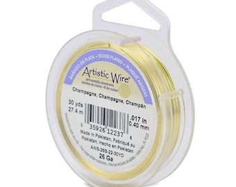 May include: A spool of 26 gauge silver-plated Artistic Wire in a champagne color. The spool is 30 yards long and 0.017 inches in diameter. The label reads "Artistic Wire" and "Champagne, Champagne, Champán".