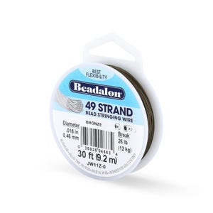 May include: A spool of Beadalon 49 strand bead stringing wire in bronze color. The label indicates a diameter of .018 inches, a break strength of 26 pounds, and a length of 30 feet. The spool features a white plastic frame with a hanging tab.