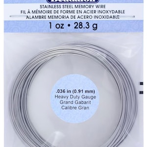 May include: A roll of silver-colored stainless steel memory wire, 0.036 inches in diameter, for jewelry making. The wire is labeled "Heavy Duty Gauge" and "1 oz. 28.3 g".