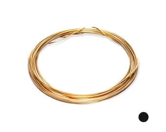 May include: A continuous coil of thin, flexible gold-colored wire arranged in a circular, layered loop. The metallic material has a smooth, reflective surface and a consistent gauge throughout the entire length of the coiled strand.
