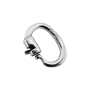 May include: A silver-colored oval-shaped clasp with a hinged closure. The clasp is made of metal and has a smooth, reflective surface. The design includes a small, curved lever for opening and closing. The clasp is likely used for jewelry or accessories.