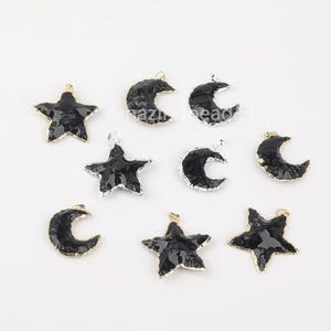 May include: A set of black and silver metal charms featuring crescent moons and stars. The charms have a textured, hammered finish and are perfect for jewelry making.