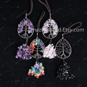 May include: Five wire wrapped tree of life pendants with different colored gemstones. The pendants are made with amethyst, rose quartz, black onyx, red jasper, and a mix of colorful stones.