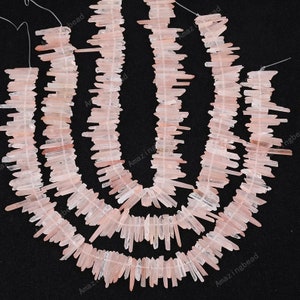 May include: A strand of pink quartz crystal points, also known as rose quartz, arranged in a cascading pattern. The crystals are translucent and have a natural, raw finish. The strand is approximately 46 cm long and is perfect for jewellery making or crystal healing.
