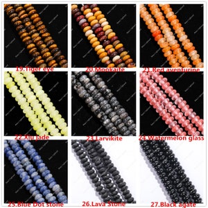 May include: A selection of gemstone beads in diverse colours, such as tiger eye, mookaite, red aventurine, xiu jade, larvikite, watermelon glass, blue dot stone, lava stone, and black agate. Each strand is labelled with its gemstone name.