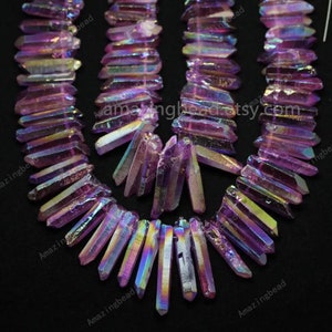 May include: A strand of iridescent purple crystal point beads. The beads are faceted and have a rainbow sheen. The beads are strung on a wire and are ready to be used in jewellery making.