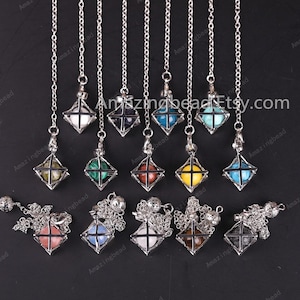 May include: Twelve silver cage pendulums with different colored gemstone balls inside. The pendulums are hanging from silver chains.