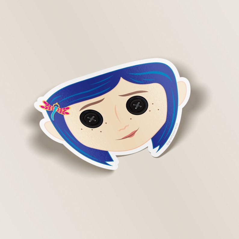 May include: A blue-haired girl with button eyes and a dragonfly hair clip. The girl is smiling and has freckles on her cheeks.