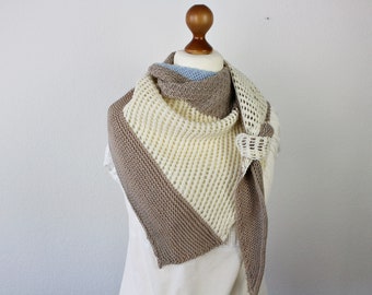 Hand-knitted asymmetrical triangular shawl with structural pattern