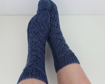 Hand-knitted socks in size 38/39 made of 6-ply sock wool in blue with cable pattern