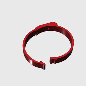 Può includere: Un anello di plastica rosso con una chiusura a cerniera. L'anello è aperto e la chiusura è sganciata.