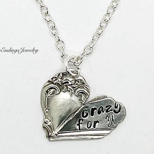 May include: Silver necklace with a heart-shaped pendant that says "crazy for you".