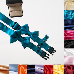 May include: A turquoise satin bow tie dog collar with two adjustable buckles. The collar is shown with a small ring attached to the collar.