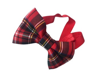 May include: Red and black plaid bow tie with an elastic headband.