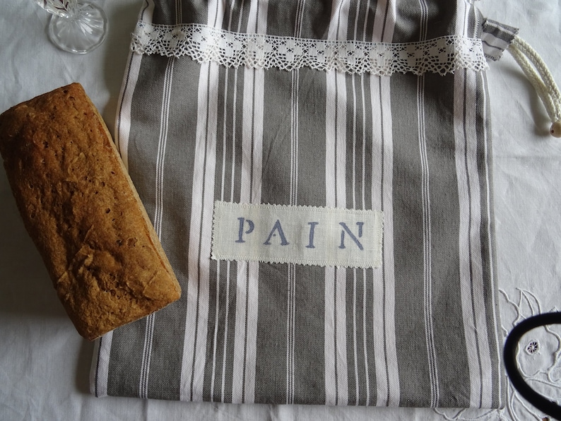 Full-lined vintage grey and white mattress canvas bread bag;