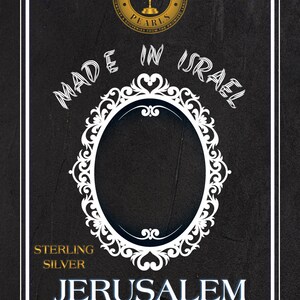 May include: A black and white image with a gold circle that says "Jerusalem Pearls Jewelry & Souvenirs from the Promised Land" with a menorah inside the circle. The text "Made in Israel" is written in a white cursive font. A white ornate frame surrounds a blank space. The text "Sterling Silver" is written in white. The text "Jerusalem" is written in blue. The text "ישראל - ירושלים" is written in blue.