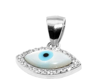 May include: A silver-toned pendant featuring an eye design. The eye has a white base with a light blue iris and a black pupil, surrounded by a border of small, clear stones. The pendant has a bail for attaching to a chain.