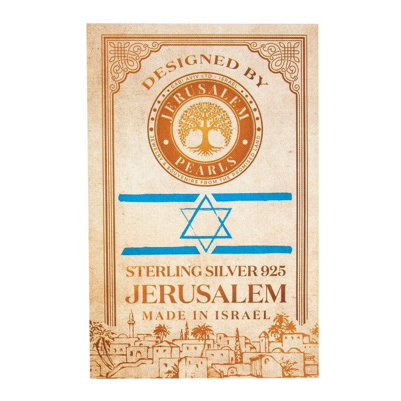 May include: A vintage-style label with a gold and blue design. The label reads "Designed by Jerusalem Pearls Jewelry & Souvenirs from the Promised Land." It also features a star of David and the text "Sterling Silver 925 Jerusalem Made in Israel".