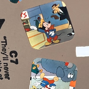 May include: A View-Master reel featuring two cartoon scenes. The top scene shows Mickey Mouse in a blue jacket and red pants talking to a dog in a suit. The bottom scene shows Mickey Mouse with a blue elephant and a small brown toy. Text reads C7.