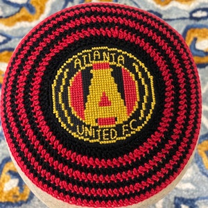 Custom kippah of you favorite American or European sports team, soccer football  team. Hand cross stitched and crocheted all cotton.