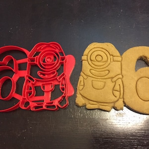 Minions cookie cutter holding the number 6. Great for your kid&#39;s sixth year minion theme birthday party. Celebrate their 6th in style!