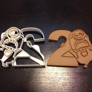 Minion Stuart Cookie Cutter holding the number 2 for your kid&#39;s second year birthday party! Celebrate their 2nd with a Minions themed party!